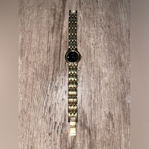 Citizen Gold watch with round, black face